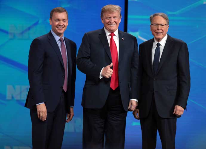 INDIANAPOLIS, INDIANA - APRIL 26: U.S. President Donald Trump gives a thumbs up to the crowd as he stands on stage along with NRA Executive Vice President Wayne LaPierre (R), and Executive Director NRA-ILA Chris Cox (L) at the NRA-ILA Leadership Forum at the 148th NRA Annual Meetings & Exhibits on April 26, 2019 in Indianapolis, Indiana. The convention, which runs through Sunday, features more than 800 exhibitors and is expected to draw 80,000 guests. (Photo by Scott Olson/Getty Images)