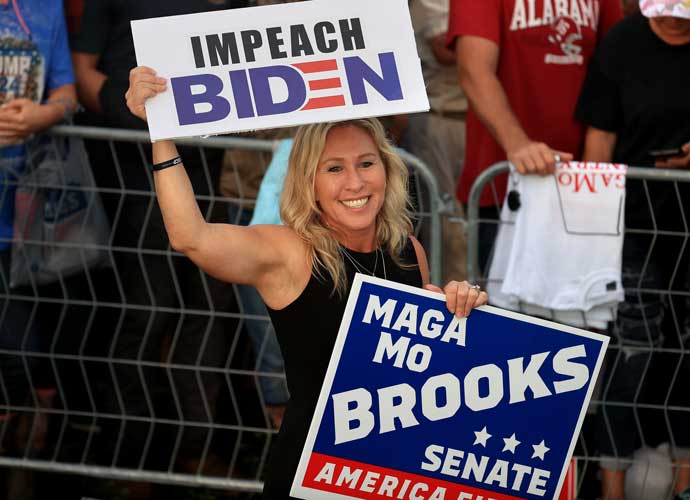 CULLMAN, ALABAMA - AUGUST 21: Rep. Marjorie Taylor Greene (R-GA) carries a campaign sign for her fellow Republican House member Rep. Mo Brooks (R-AL) during former U.S. President Donald Trump's 