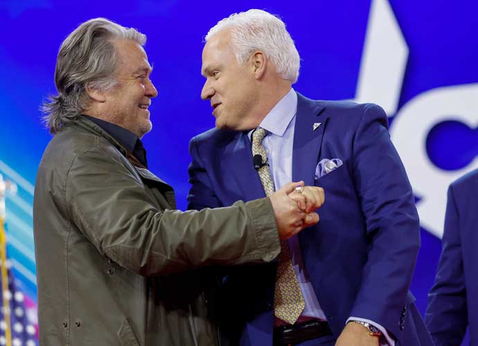 NATIONAL HARBOR, MARYLAND - FEBRUARY 24: Chairman of American Conservative Union Matt Schlap (R) gives Steve Bannon (L), former advisor to former President Donald Trump, a high five as he walks onstage at the Conservative Political Action Conference (CPAC) at the Gaylord National Resort Hotel And Convention Center on February 24, 2024 in National Harbor, Maryland. Attendees descended upon the hotel outside of Washington DC to participate in the four-day annual conference and hear from conservative speakers from around the world who range from journalists, U.S. lawmakers, international leaders and businessmen. (Photo by Anna Moneymaker/Getty Images)