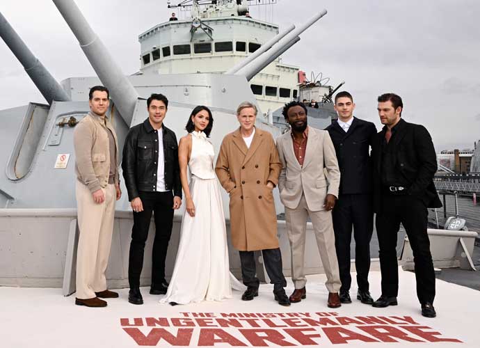LONDON, ENGLAND - MARCH 22: Henry Cavill, Henry Golding, Eiza González Rivera, Cary Elwes, Babs Olusanmokun, Hero Fiennes Tiffin and Alex Pettyfer attend the photocall for 