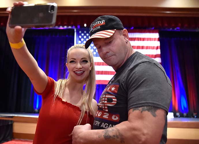 LAS VEGAS, NV - NOVEMBER 06: Mindy Robinson (L) takes a selfie with John Wayne Bobbitt at the Nevada Republican Party's election results watch party at the South Point Hotel & Casino on November 6, 2018 in Las Vegas, Nevada. Incumbent Republican Sen. Dean Heller (R-NV) is in a tight Senate race with Democratic candidate Rep. Jacky Rosen (D-NV). (Photo by David Becker/Getty Images)
