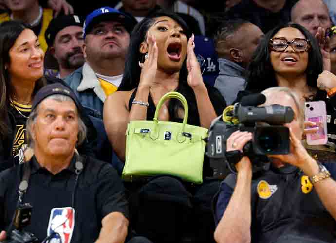 LOS ANGELES, CALIFORNIA - APRIL 7: Rapper Megan Thee Stallion, holding her Birkin bag, cheers for D'Angelo Russell #1 of the Los Angeles Lakers after scoring a three point basket during the second half against the Minnesota Timberwolves at Crypto.com Arena on April 7, 2024 in Los Angeles, California. (Photo by Kevork Djansezian/Getty Images)
