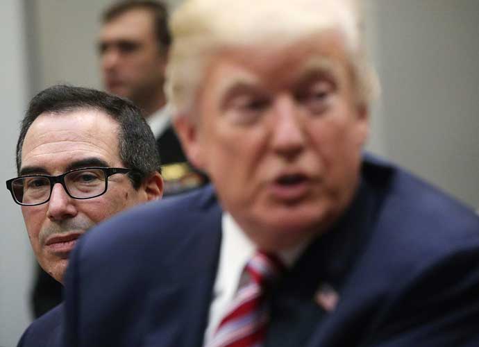 WASHINGTON, DC - OCTOBER 31: U.S. President Donald Trump (R) speaks to business leaders as Secretary of the Treasury Steven Mnuchin (L) looks on during a Roosevelt Room event October 31, 2017 at the White House in Washington, DC. President Trump participated in a 