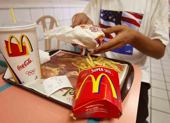MIAMI BEACH, FL - JULY 18: Jeff Baughman unwraps his Double Quarterpounder with cheese and a Super Fries and a Super Coke on July 18, 2002 at a McDonalds in Miami Beach, Florida. The health effects of an American diet of super-sized fast foods are becoming apparent as increasing numbers of children and adults are being treated for obesity. Studies seem to point to the fact that many overweight children and adults get a large portion of their calories by consuming too many sodas and sweetened juices and beverages. Sweetened drinks + 