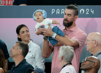 PARIS, FRANCE - JULY 30: Michael Phelps and his baby Nico Phelps attend the Artistic Gymnastics Women's Team Final during day four of the Paris 2024 Olympic Games at the Paris Arena on July 30, 2024 in Paris, France. (Photo by Jean Catuffe/Getty Images)