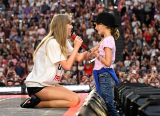 AMSTERDAM, NETHERLANDS - JULY 04: Taylor Swift speaks to a kid onstage during "Taylor Swift | The Eras Tour" at Johan Cruijff Arena on July 04, 2024 in Amsterdam, Netherlands. (Photo by Carlos Alvarez/Getty Images for TAS Rights Management)