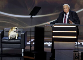 MILWAUKEE, WISCONSIN - JULY 16: West Virginia Gov. Jim Justice speaks on stage with his dog, Babydog on the second day of the Republican National Convention at the Fiserv Forum on July 16, 2024 in Milwaukee, Wisconsin. Delegates, politicians, and the Republican faithful are in Milwaukee for the annual convention, concluding with former President Donald Trump accepting his party's presidential nomination. The RNC takes place from July 15-18. (Photo by Chip Somodevilla/Getty Images)