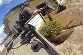 VIDEO: Newly Released Bodycam Footage Shows Dramatic Rescues Of People On Rooftops & Trees Amid Hurricane Helene